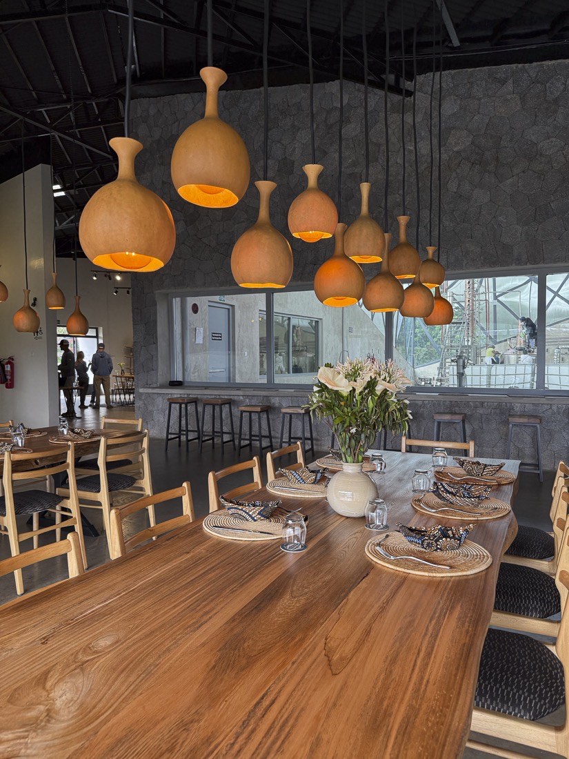 The communal table at Kinigi Table under handmade gourd lamps