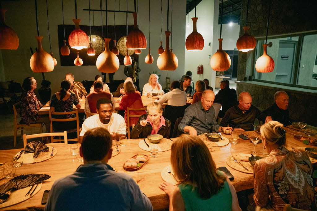 Guests dining at Kinigi Table